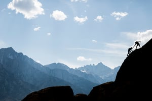 An image of a person climbing a mountain and helping others - Rimo3 Resources